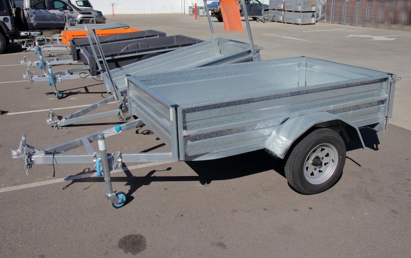 A row of trailers are parked in a parking lot — Marx Forster Tyres & Mechanical In Forster, NSW