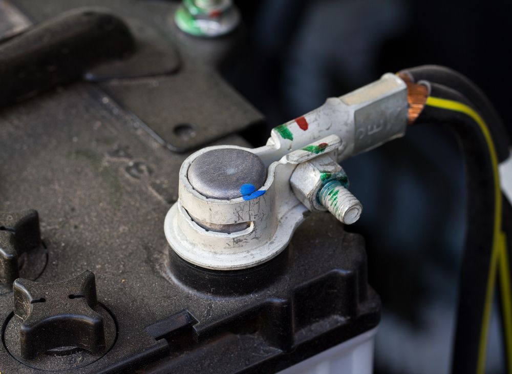 A Close Up of a Car Battery With a Cable Attached to It — Marx Forster Tyres & Mechanical In Forster, NSW