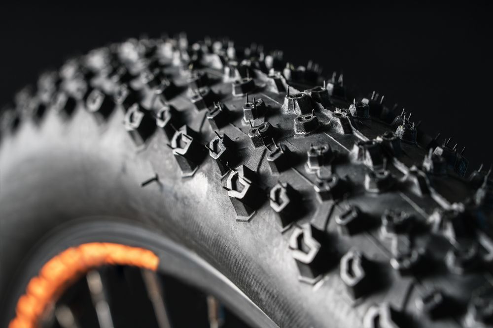 A Close Up of a Bicycle Tyre on a Black Background — Marx Forster Tyres & Mechanical In Forster, NSW