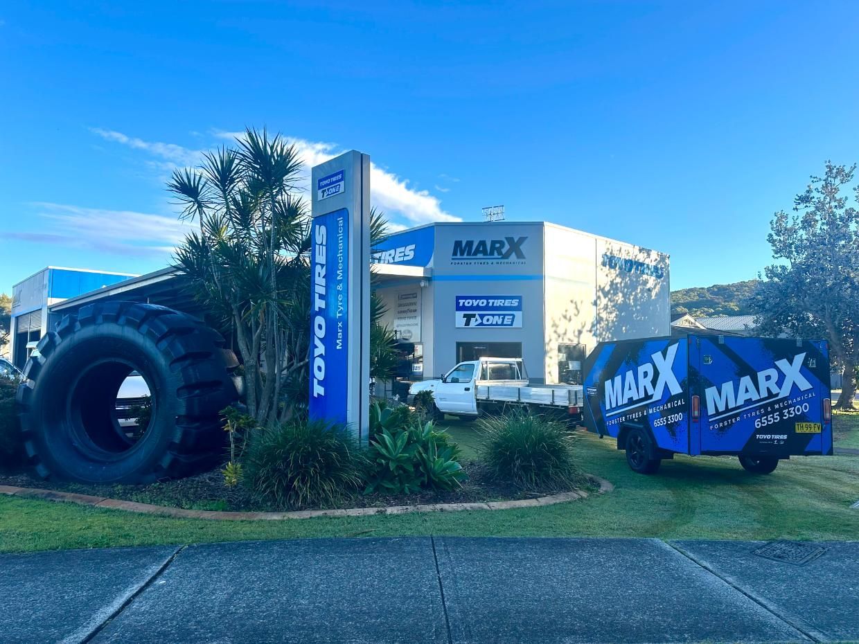 A Large Tyre is Sitting in Front of a Tyre Store — Marx Forster Tyres & Mechanical In Forster, NSW