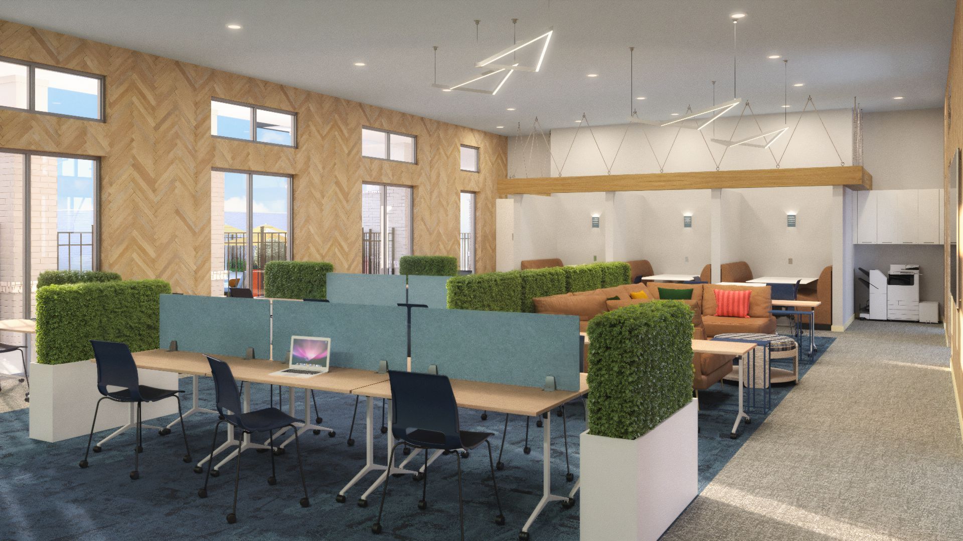 Modern open office with desks, green dividers, chairs, and large windows in a bright workspace