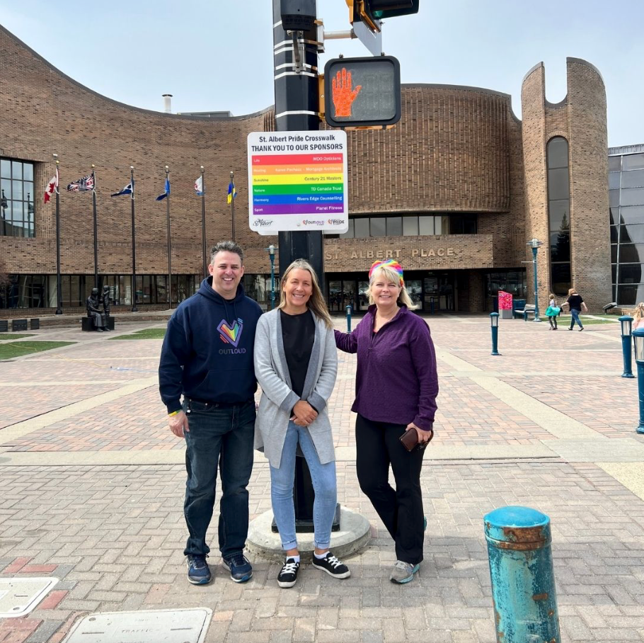 A group of people standing in front of a brick building