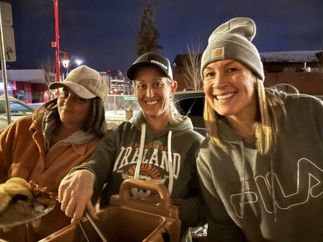 Three women wearing ireland sweatshirts are posing for a picture