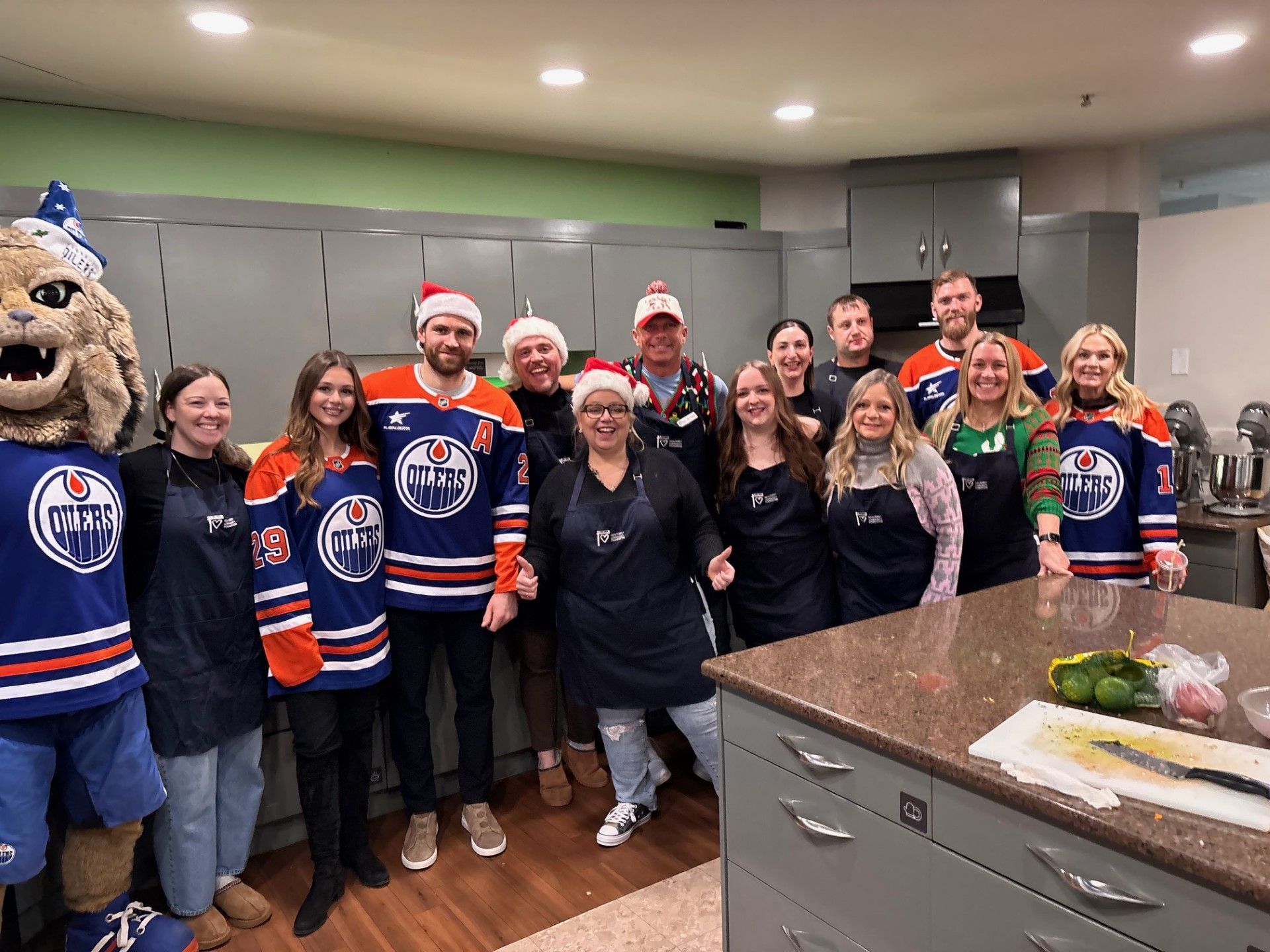 A group of people are posing for a picture in a kitchen.
