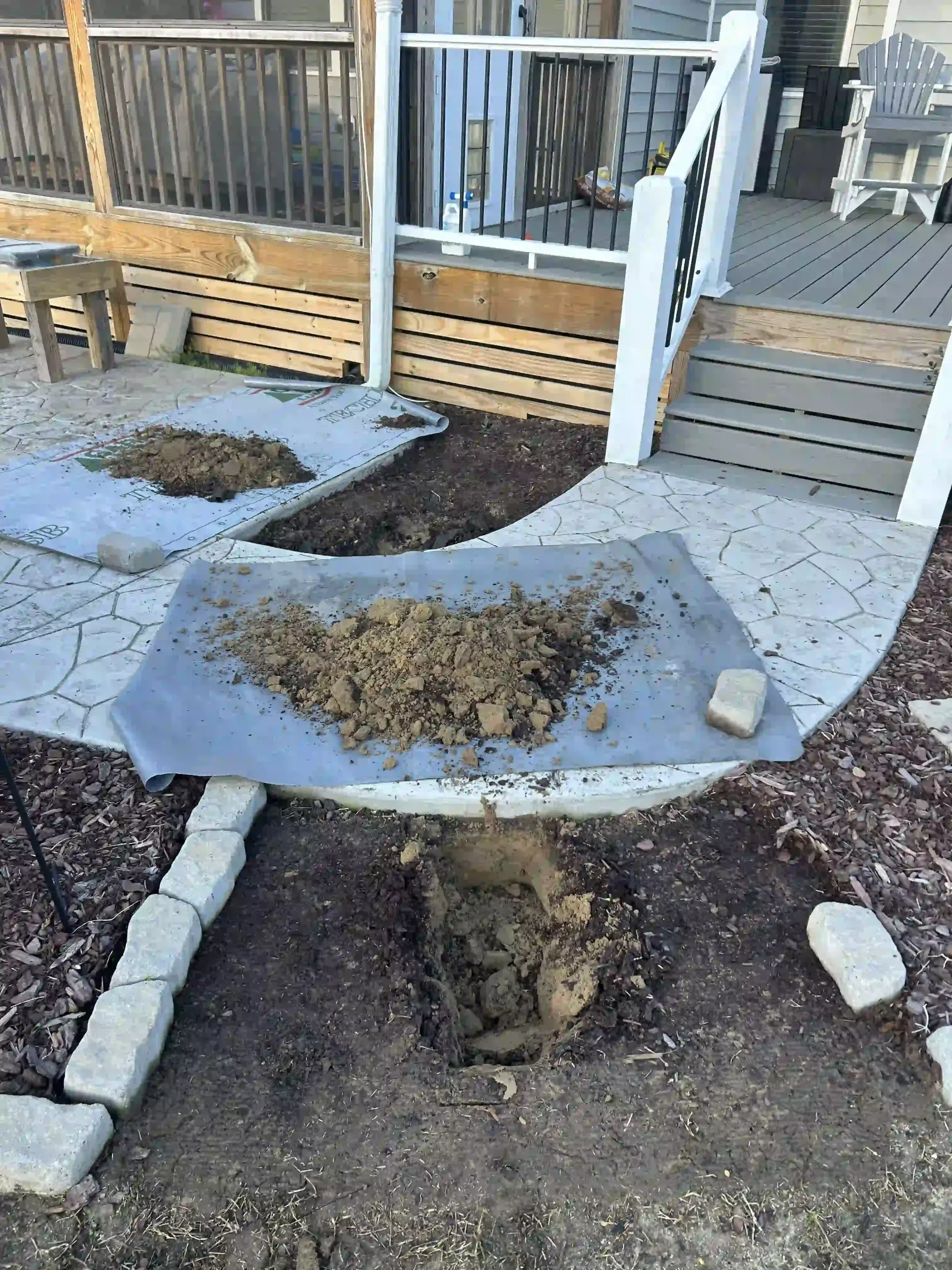Front yard walkway under construction with dirt, pavers, and a porch ramp leading to steps