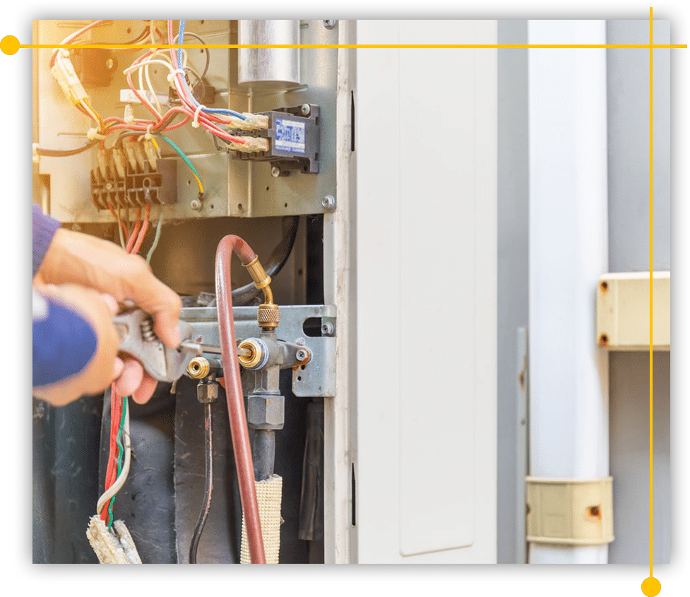 A person is working on an air conditioner with a wrench. A person is working on an air conditioner with a wrench.
