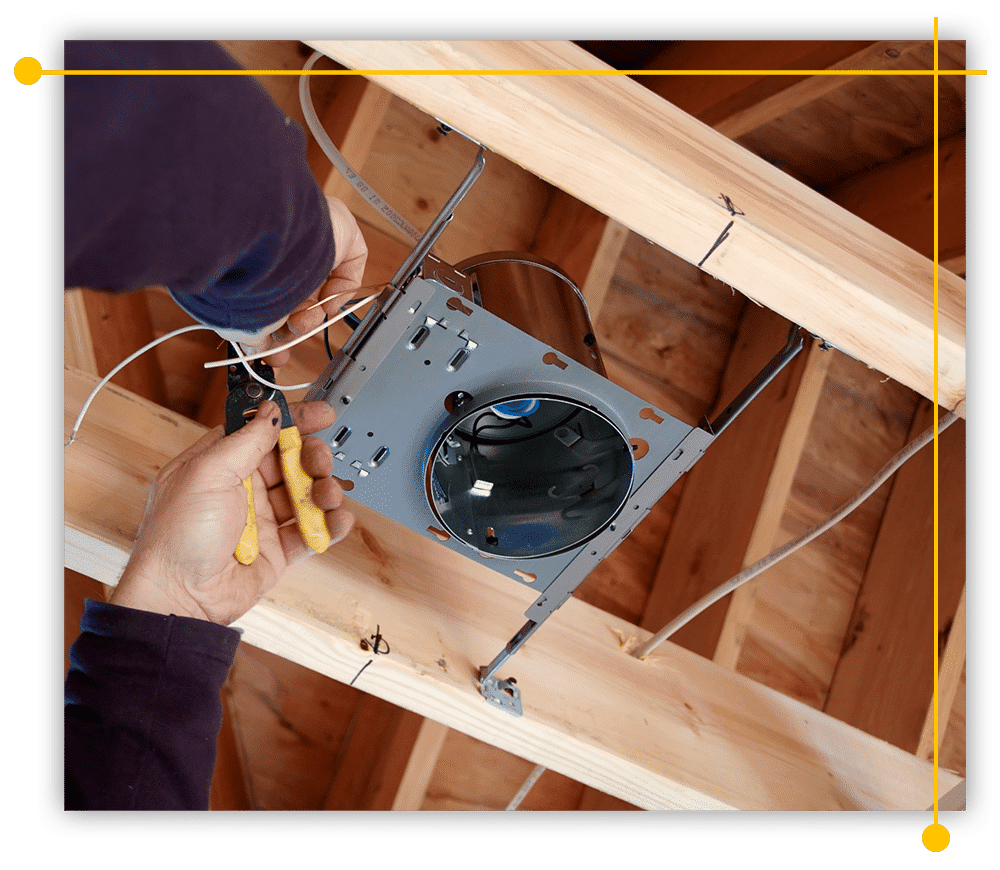 A person is working on a light fixture in the ceiling of a house. A person is working on a light fixture in the ceiling of a house.