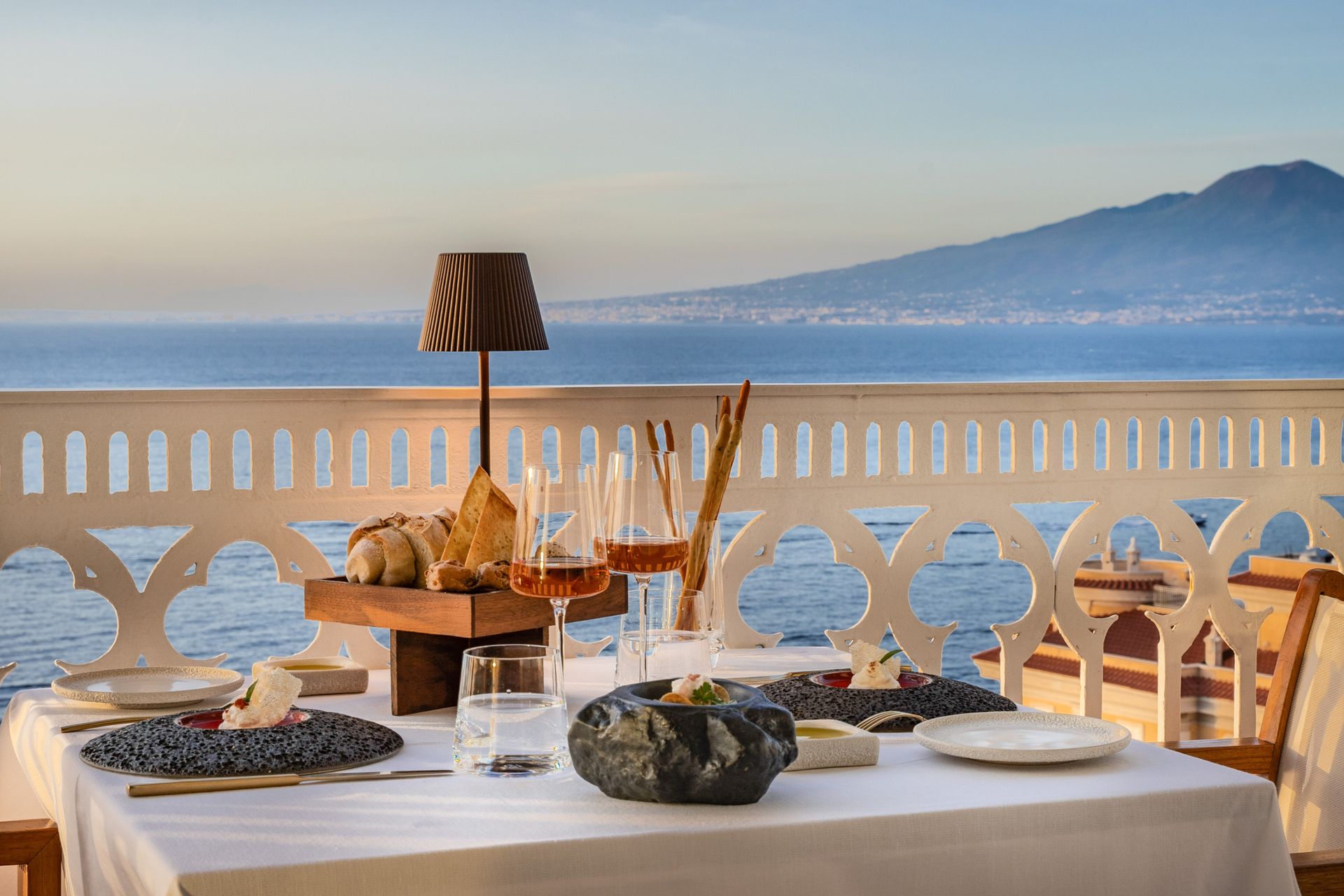 Dinner table at sunset hour on the terrace of Vesuvio Panoramic Restaurant, closing the tour's final evening
