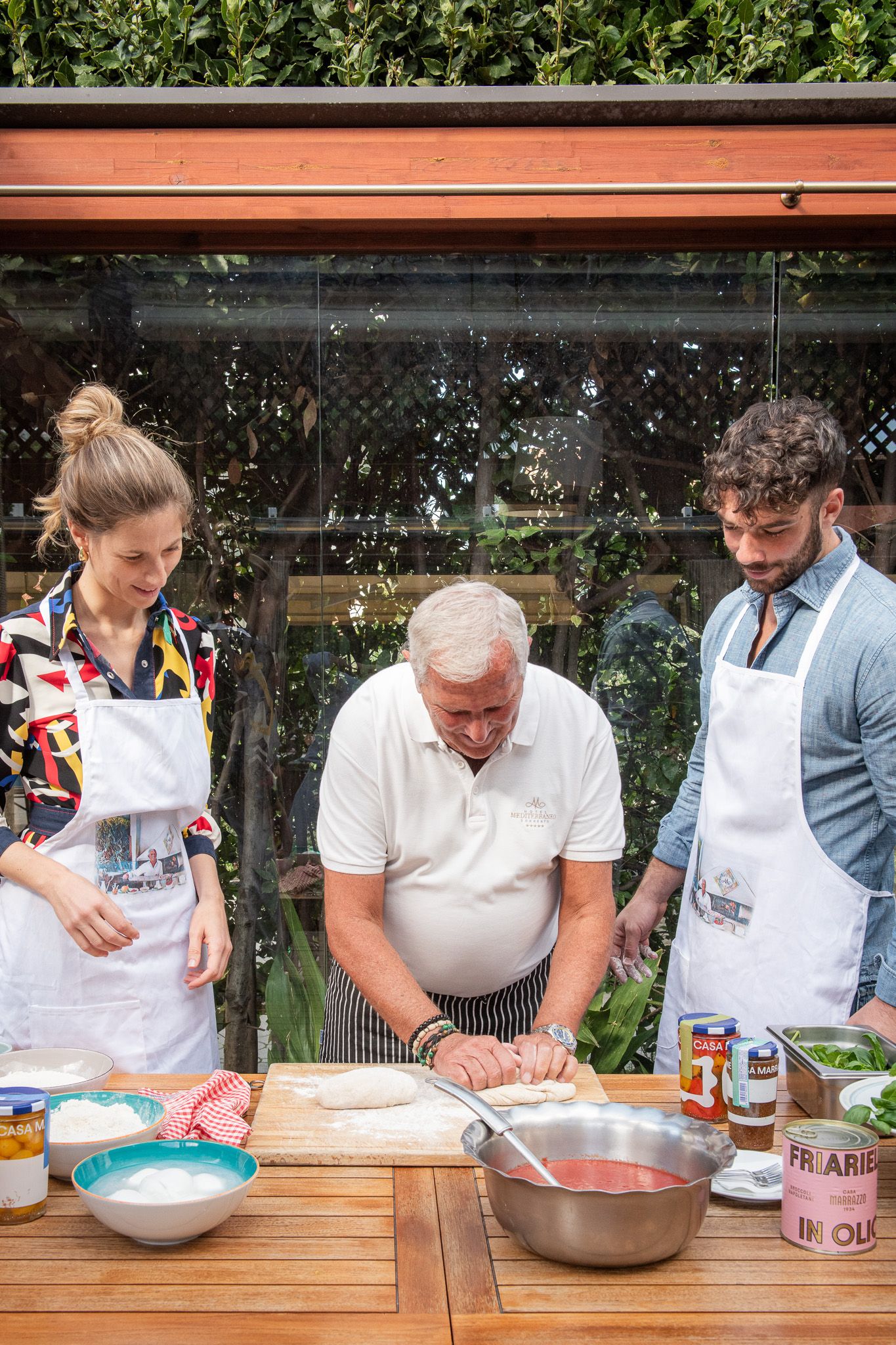 Benito kneading pizza dough for guests during a cooking class at Hotel Mediterraneo, part of the 3-day Sorrento Coast tour