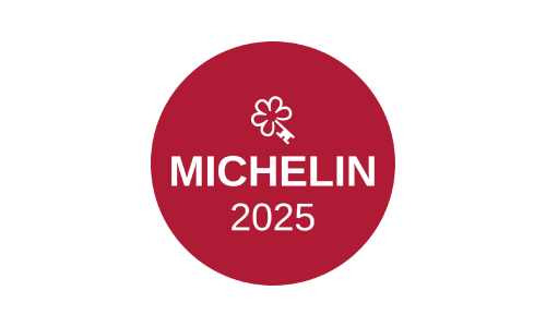 A red circle logo featuring a white Michelin key icon above the text 