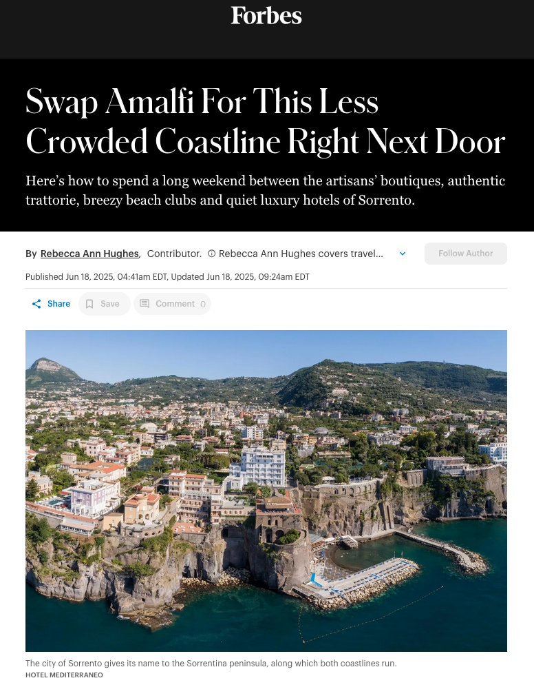 Aerial view of Sorrento, Italy, with historic buildings on a rocky cliff overlooking the turquoise Mediterranean Sea.