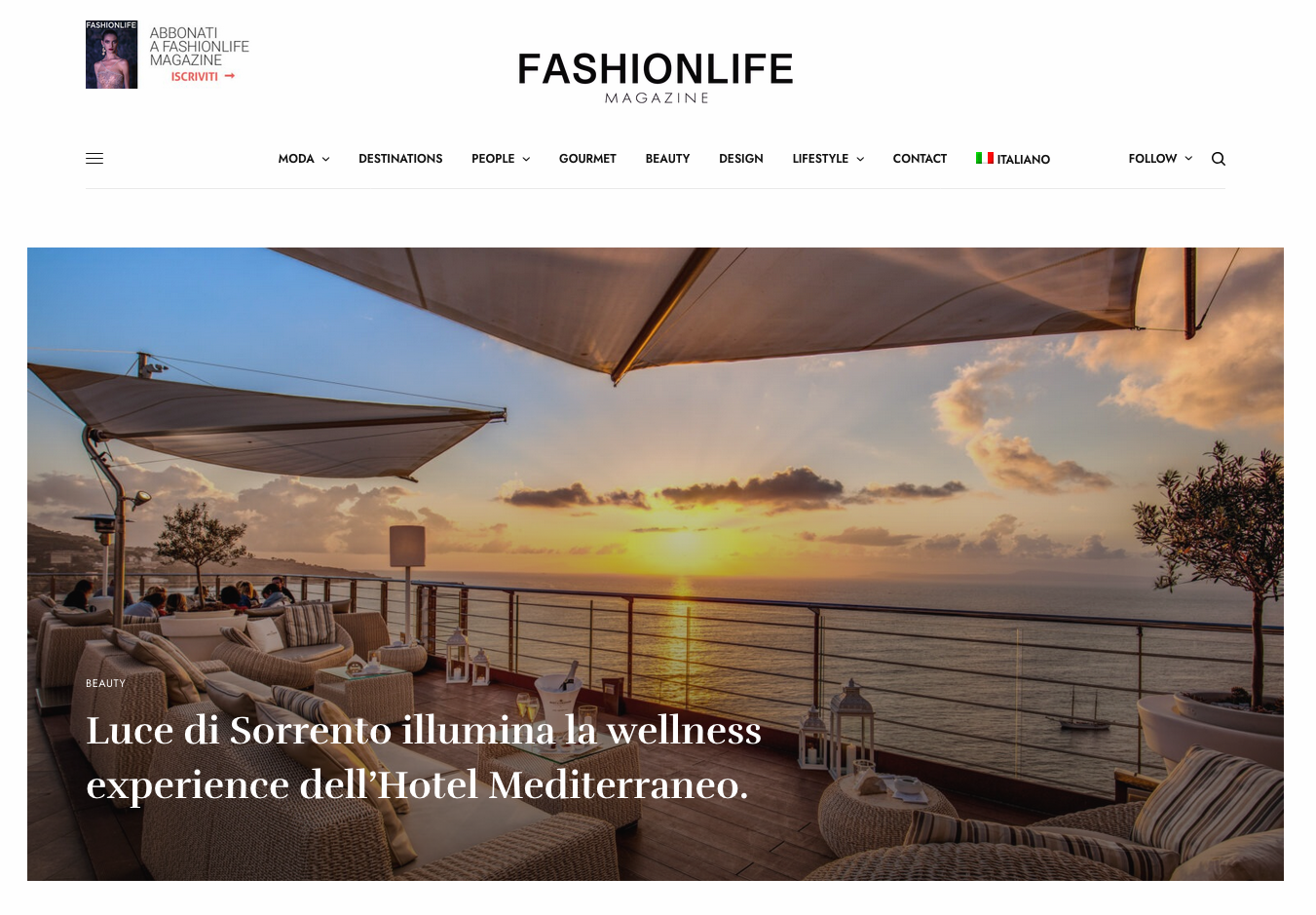 A terrace at sunset overlooking the sea, featuring lounge seating and umbrellas at Hotel Mediterraneo in Sorrento.