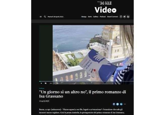 A screenshot of a video featuring a person holding the book 