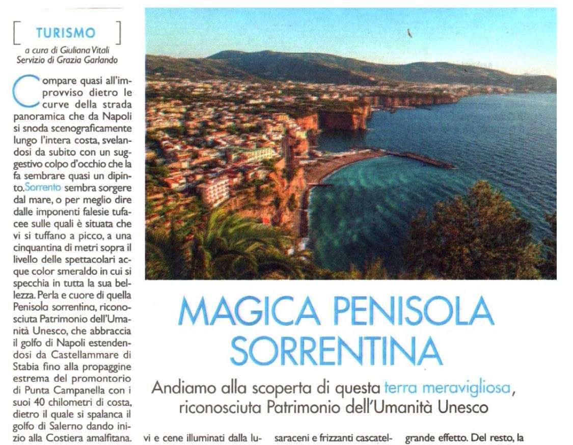 A travel article header featuring a coastal view of the Sorrentine Peninsula with steep cliffs, a beach, and blue sea.