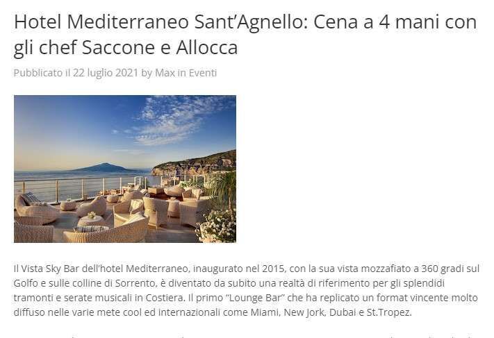 Terrace of the Vista Sky Bar at Hotel Mediterraneo, featuring wicker lounge chairs overlooking the sea and mountains.