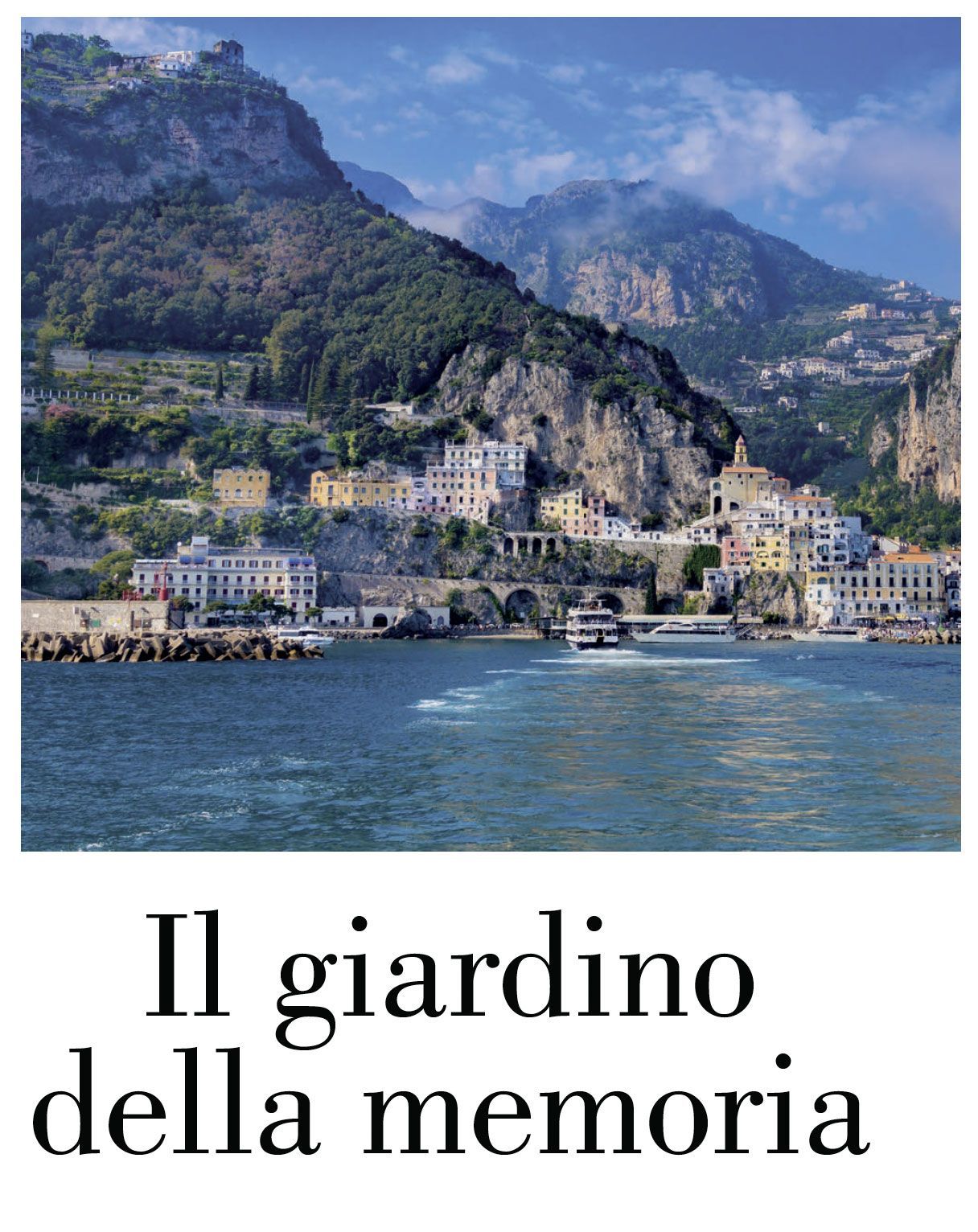 A Mediterranean coastal town nestled against a steep, sunlit mountain slope above a blue sea.