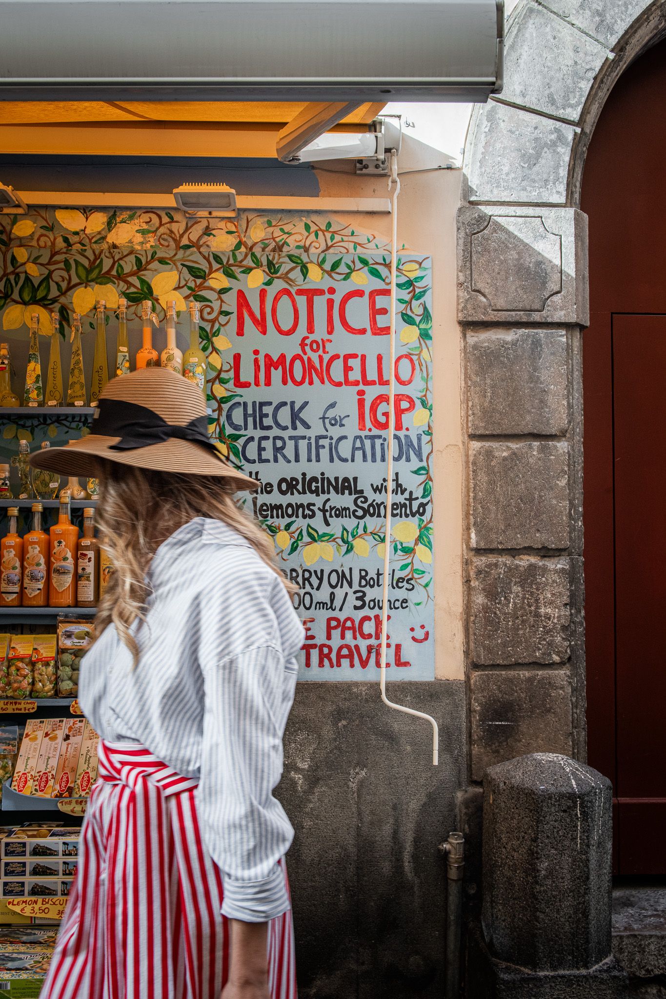 Walking tour through Sorrento's old town, past a traditional limoncello shop