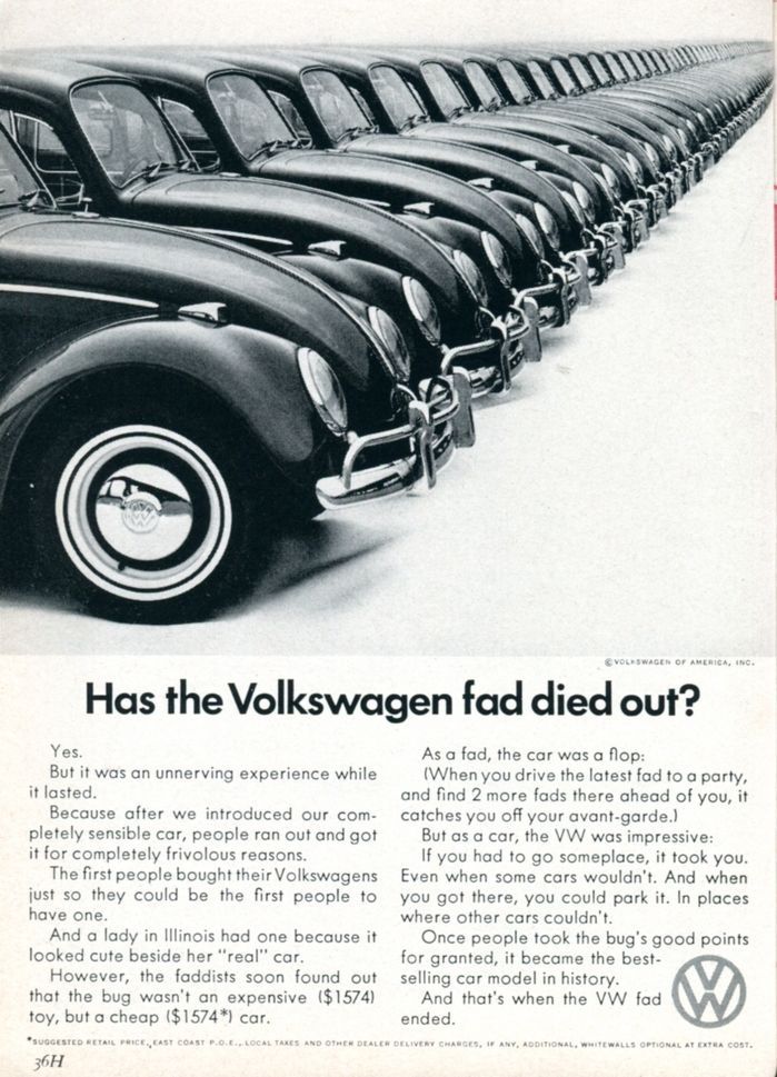 A black and white photo of a row of volkswagen cars.