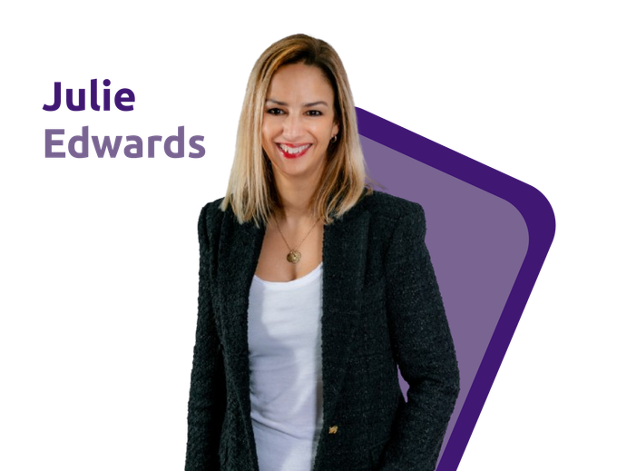 Julie Edwards smiling beside a purple geometric shape, wearing a black blazer and white top