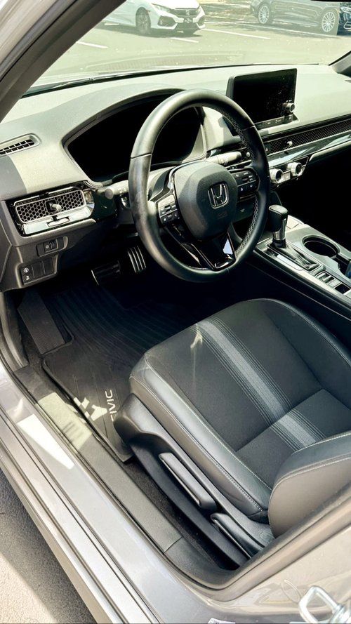 A close up of the interior of a car with the door open.