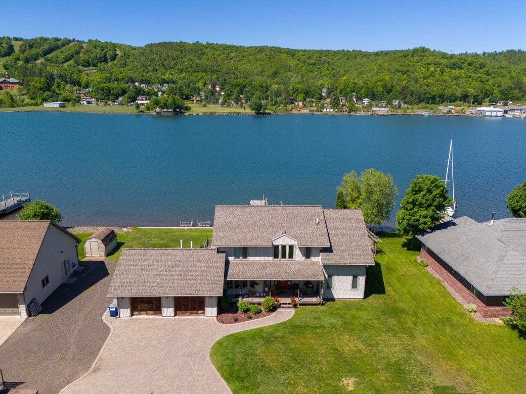 An aerial view of a house next to a lake.