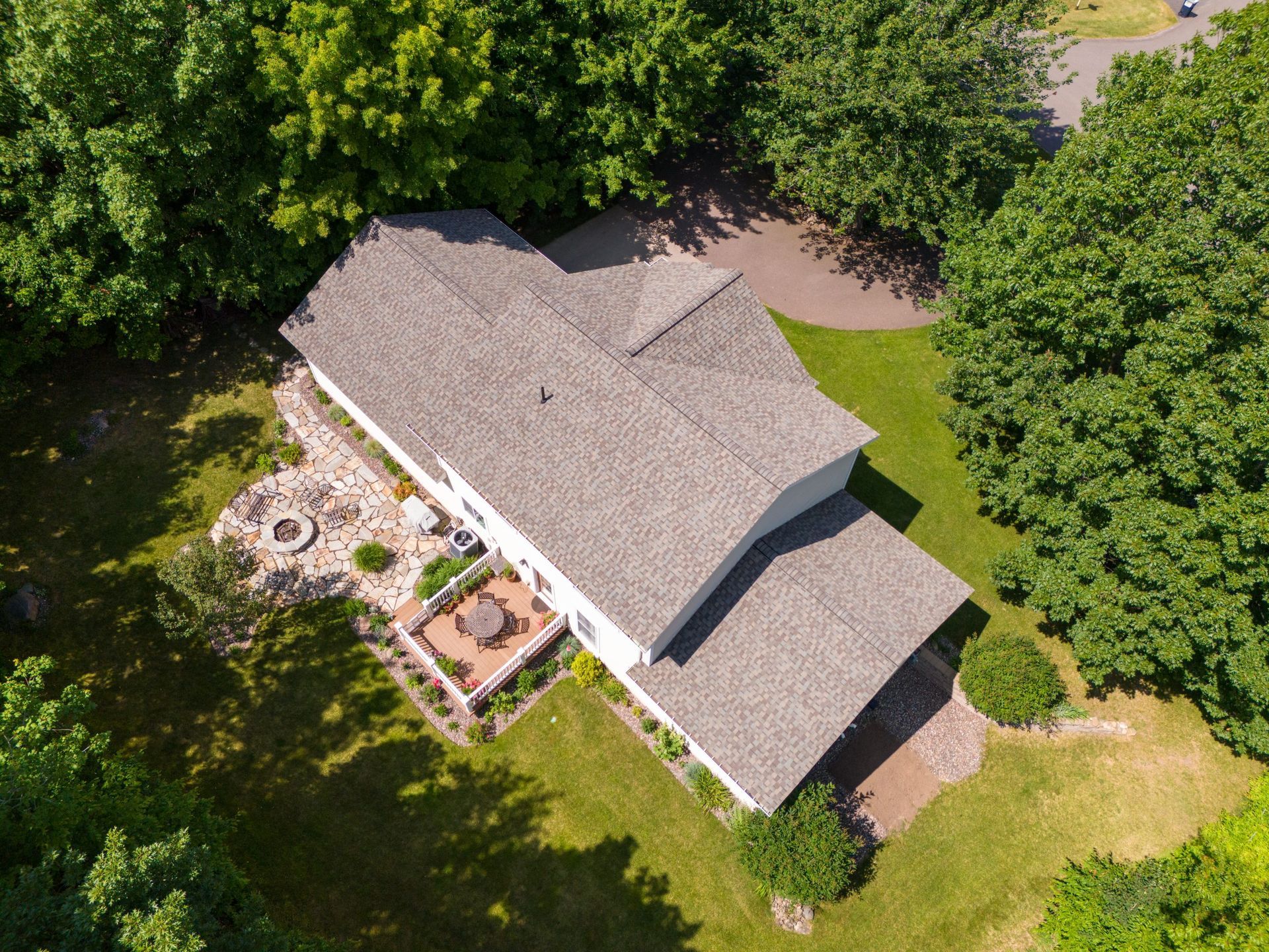 An aerial view of a house with a fire pit in the backyard