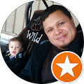 A man and a baby are sitting in a car seat.