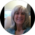 A woman with gray hair is smiling in a circle.
