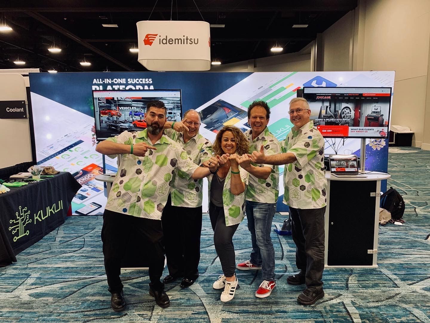 A group of people are posing for a picture at a convention.