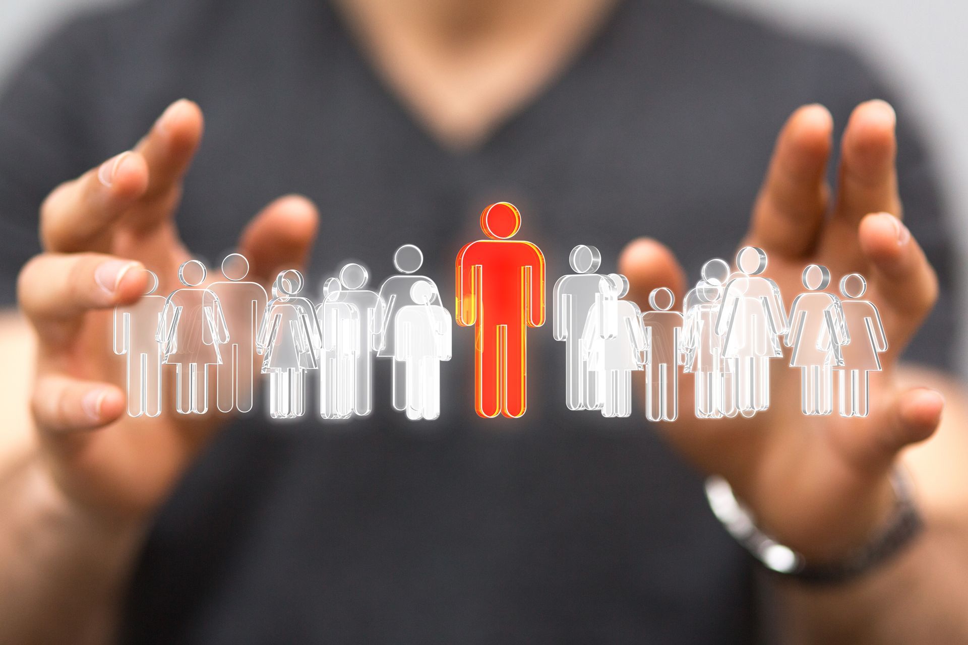 A man is holding a group of people in his hands.