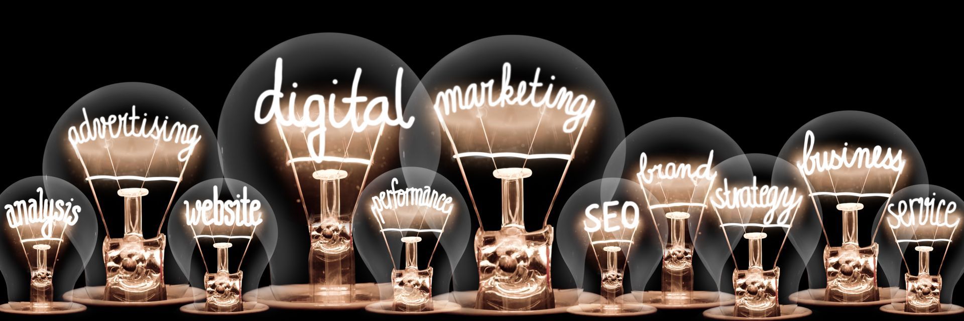 A row of light bulbs with the words digital marketing written on them