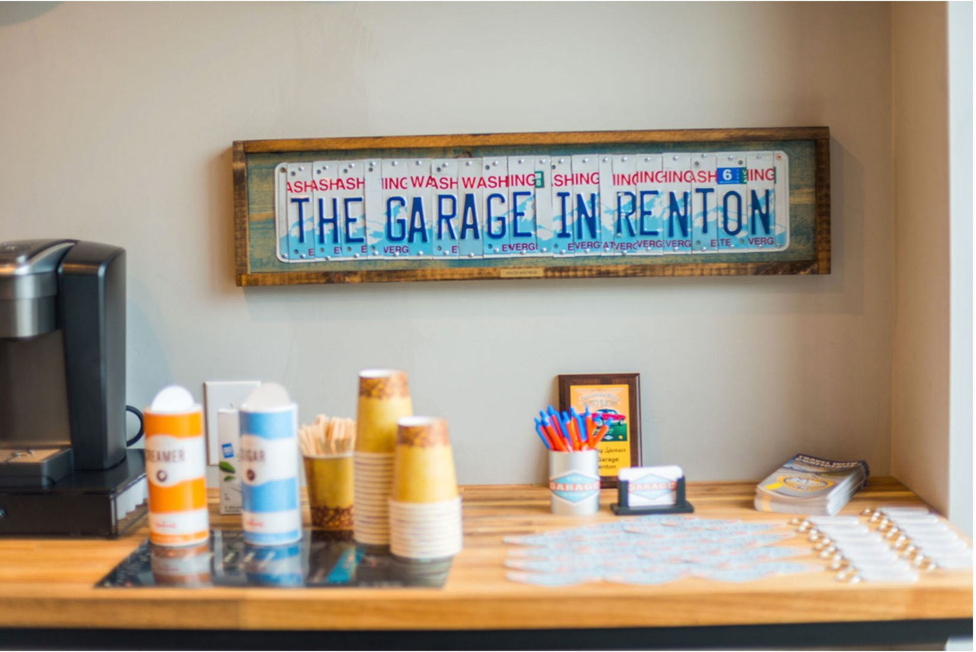 There is a sign on the wall that says `` the garage in renton ''.
