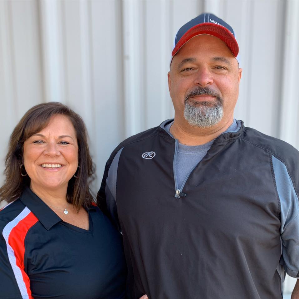 A man and a woman are posing for a picture together.