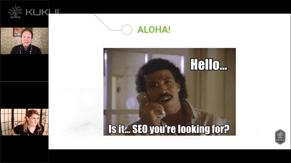 A man with a mustache is talking on a phone and says hello