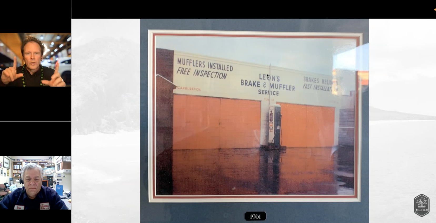 A man is standing in front of a picture of a building.