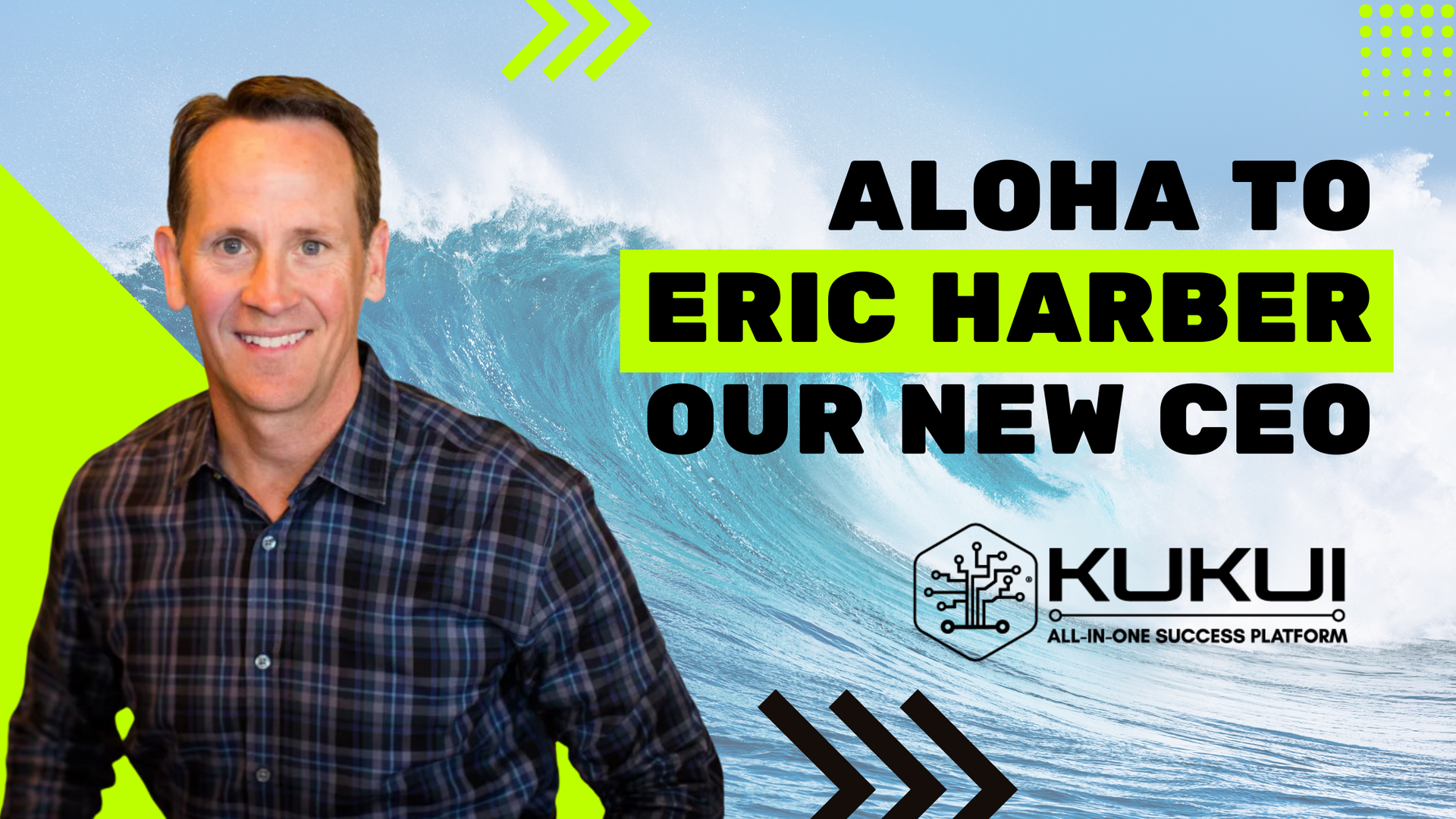 A man in a plaid shirt is standing in front of a wave.