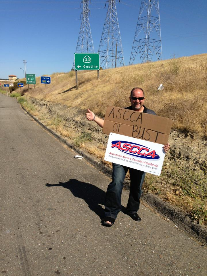A man holding a sign that says ascoa against bust