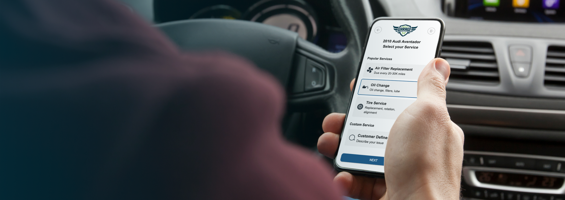 Person holding a smartphone with a ride-hailing app open in a car interior