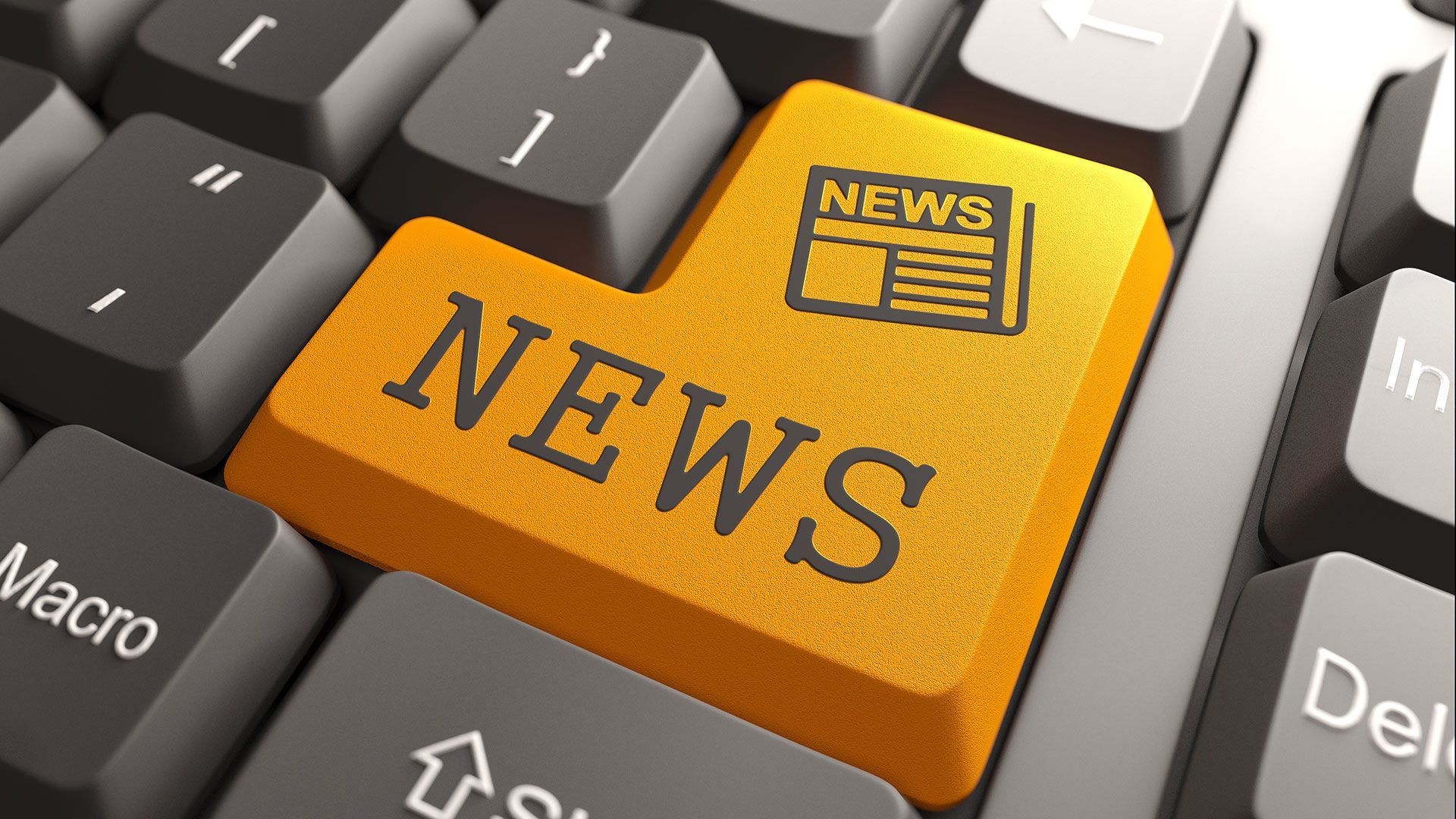 A keyboard with a yellow key that says news