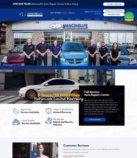 Auto repair shop team posing in front of a blue truck outside a service center