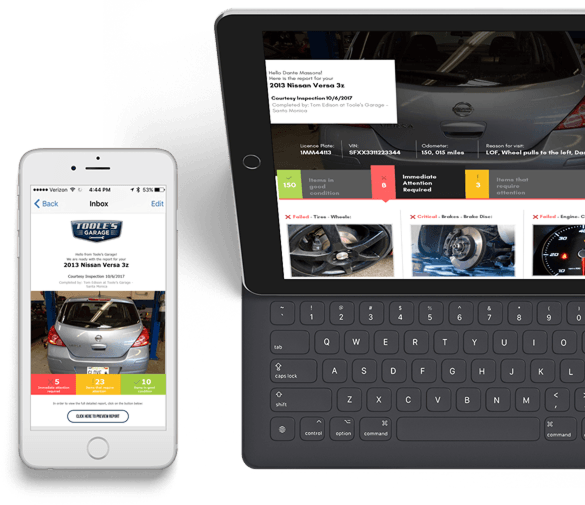 White iPhone and black tablet displaying a car repair website with vehicle photos and a keyboard case