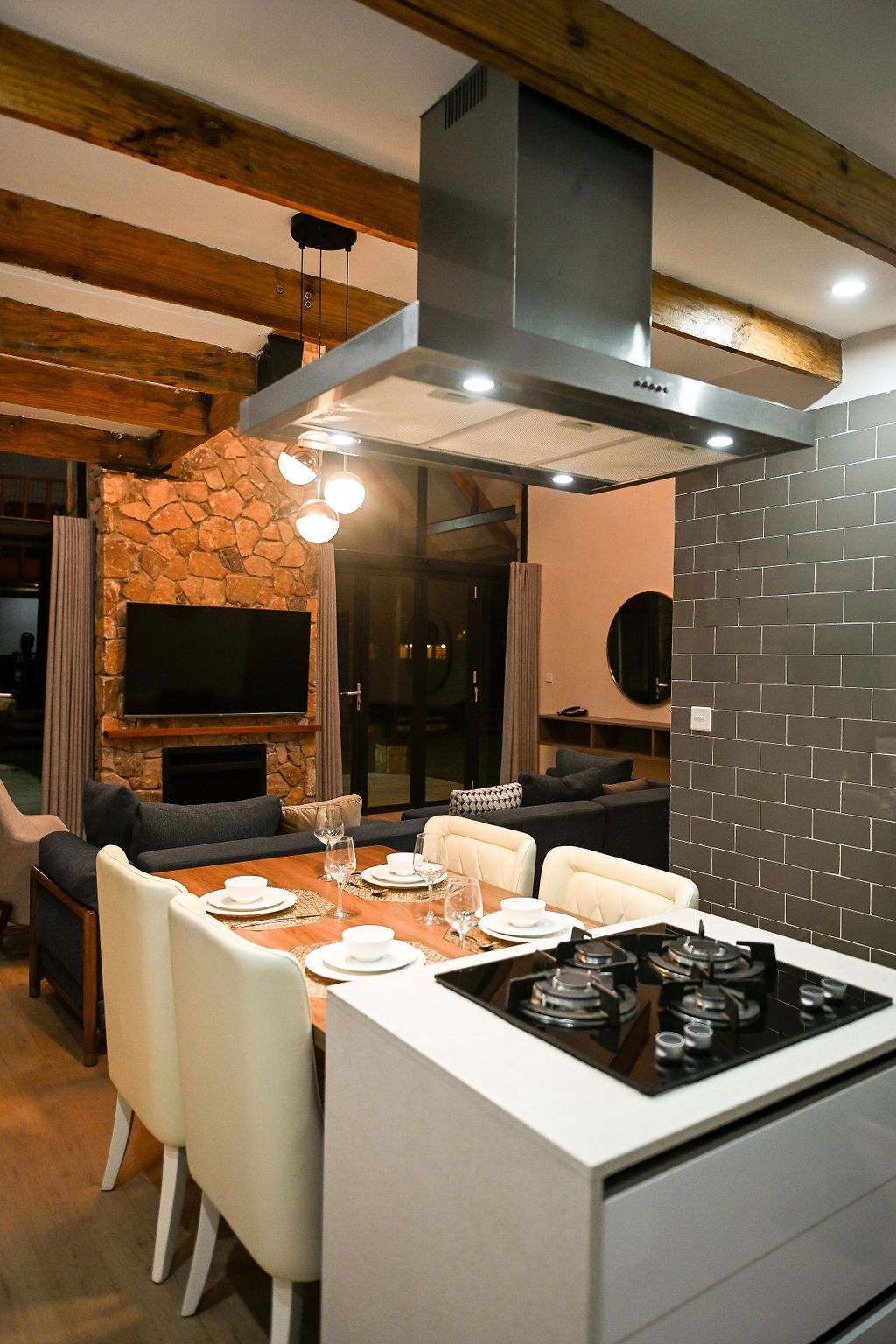 A stone house with a swimming pool in front of it.