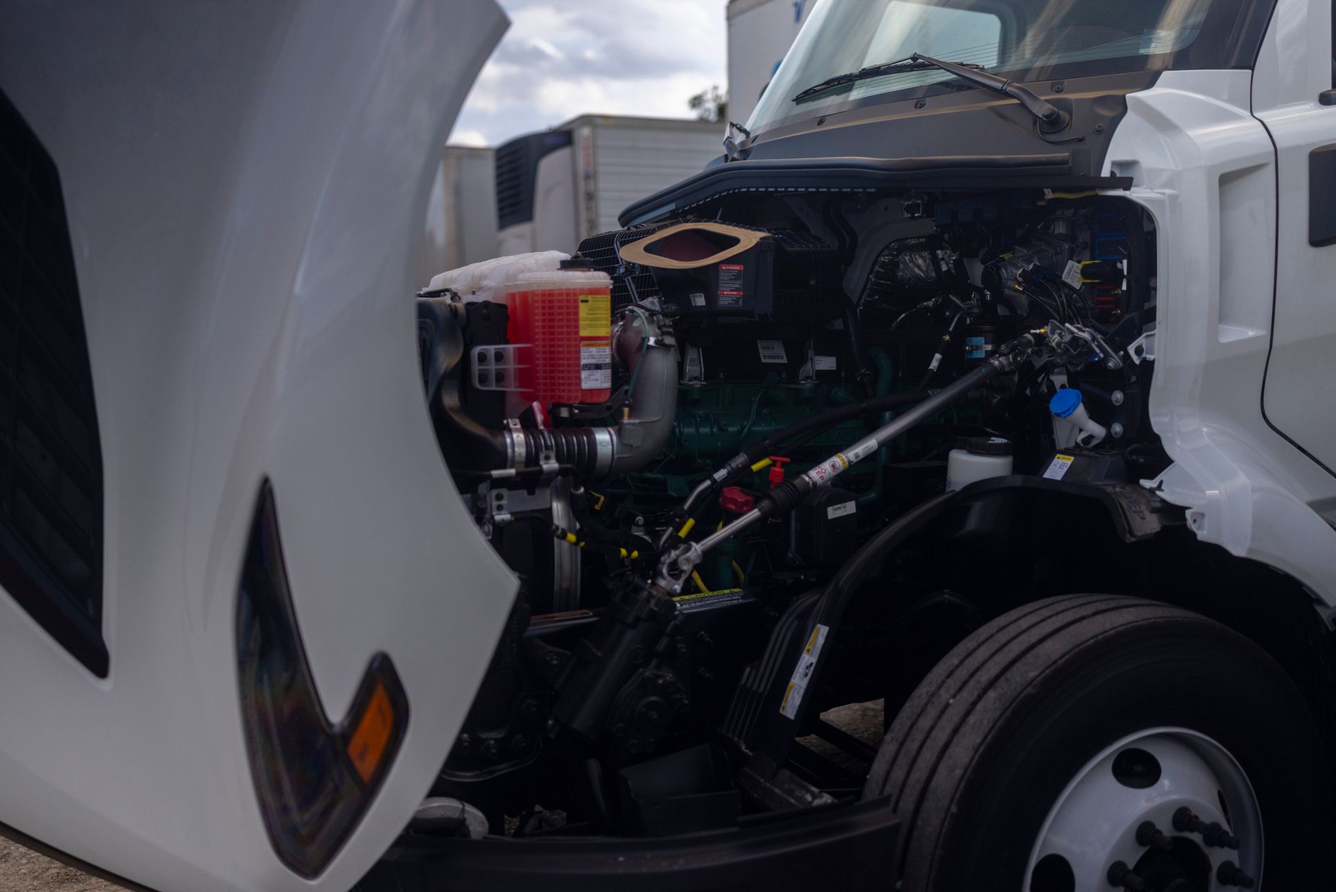 Engine bay of a truck with the hood open, revealing the engine and various components.