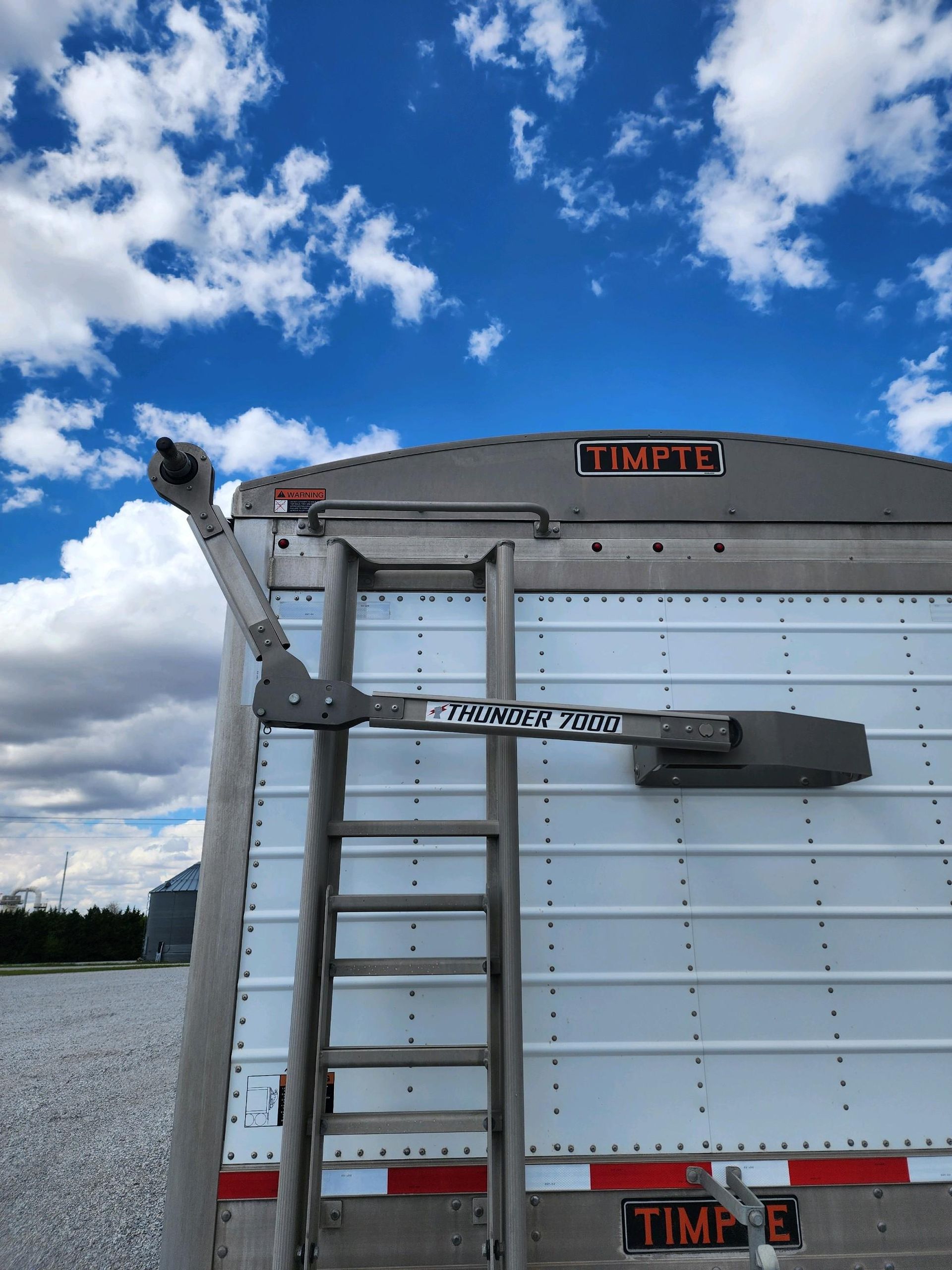 A trailer with a ladder attached to the back of it