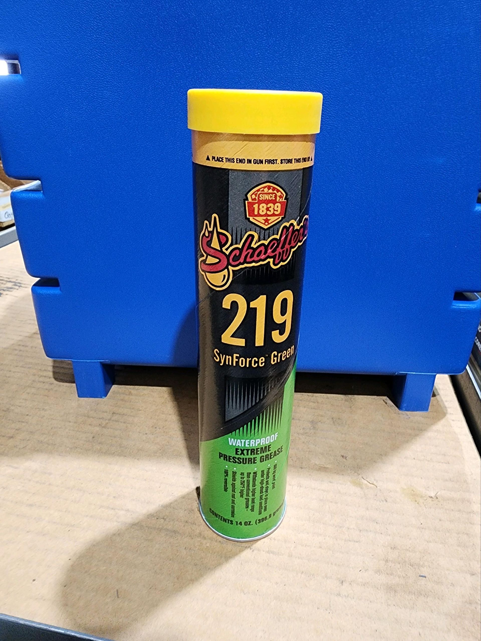 A can of 219 is sitting on a wooden table.