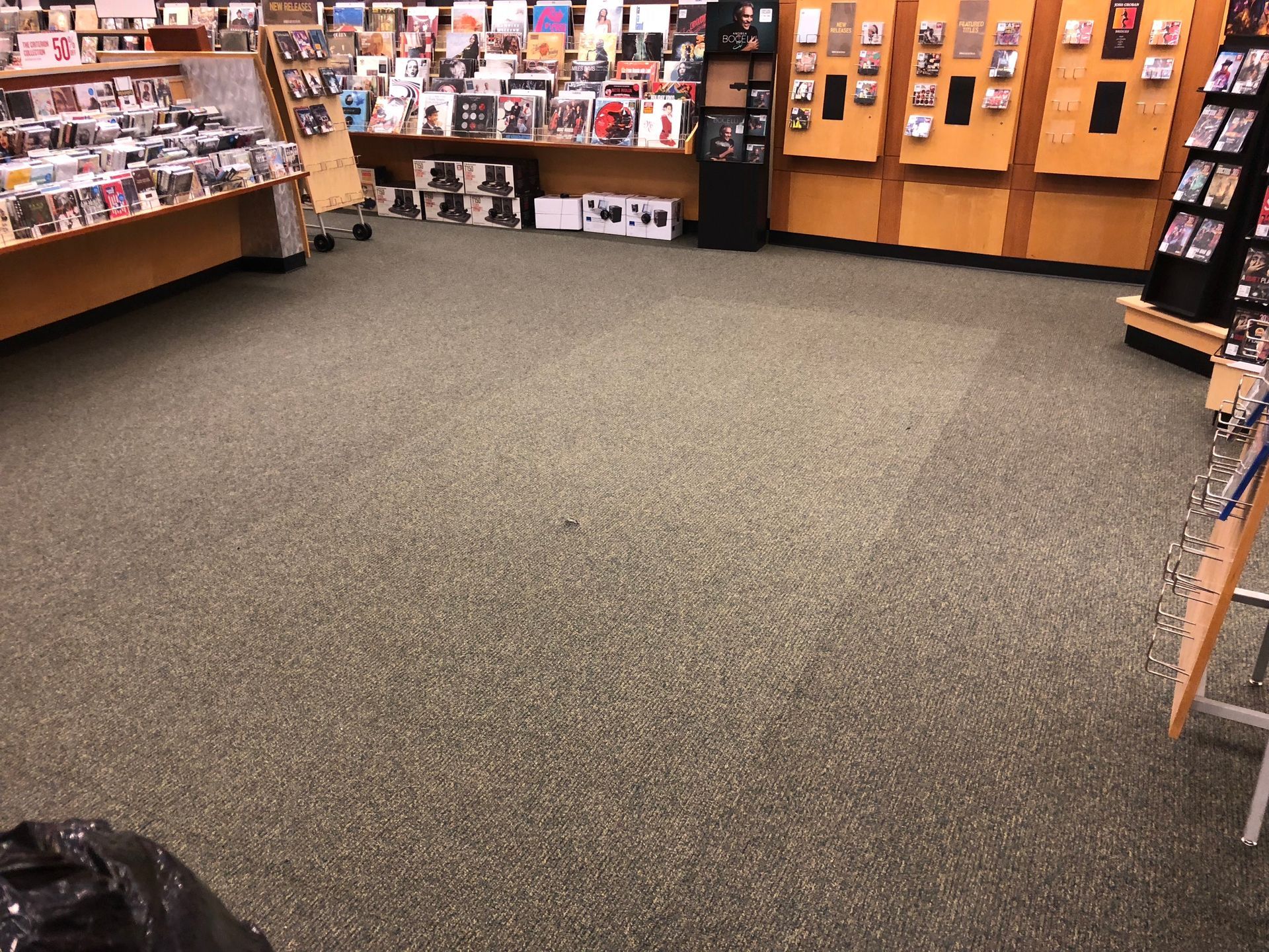 Area of Carpet no longer missing in book store where cabinet had been removed after Carpets by Chris Stretching & Repair patched it perfectly