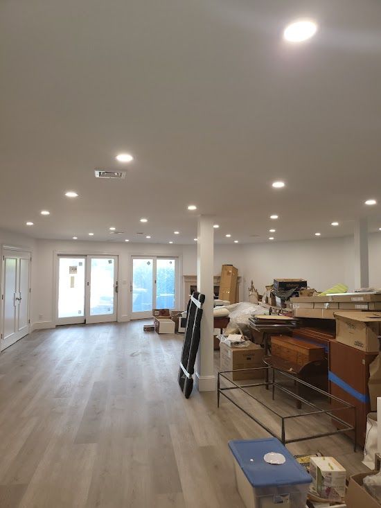 A large room with a lot of furniture and boxes in it.