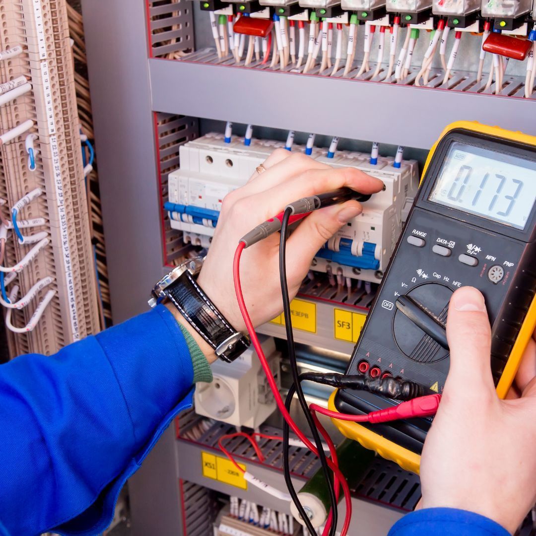A person is using a multimeter with the number 0173 on the screen