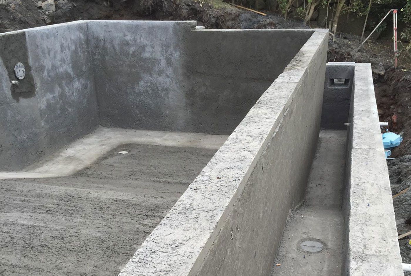 Concrete shell of an infinity pool under construction, showing overflow channel. 