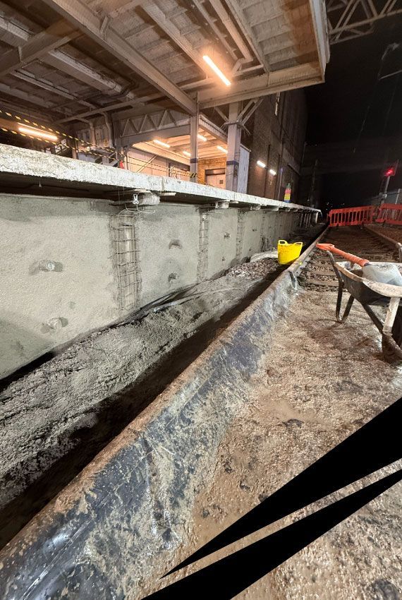 Leigh-on-Sea Railway station at night, showing concrete repairs and stabilisation of a platform retaining wall.